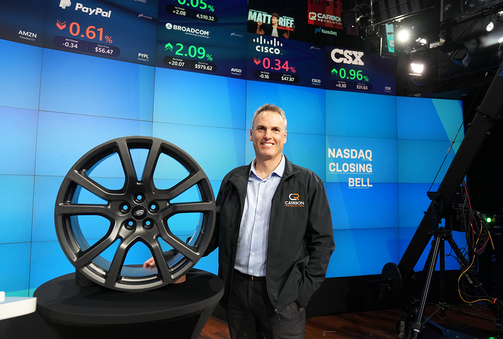 Carbon Revolution CEO, Jake Dingle with a wheel for the 2024 Range Rover Sport SV, at Nasdaq headquarters in New York.